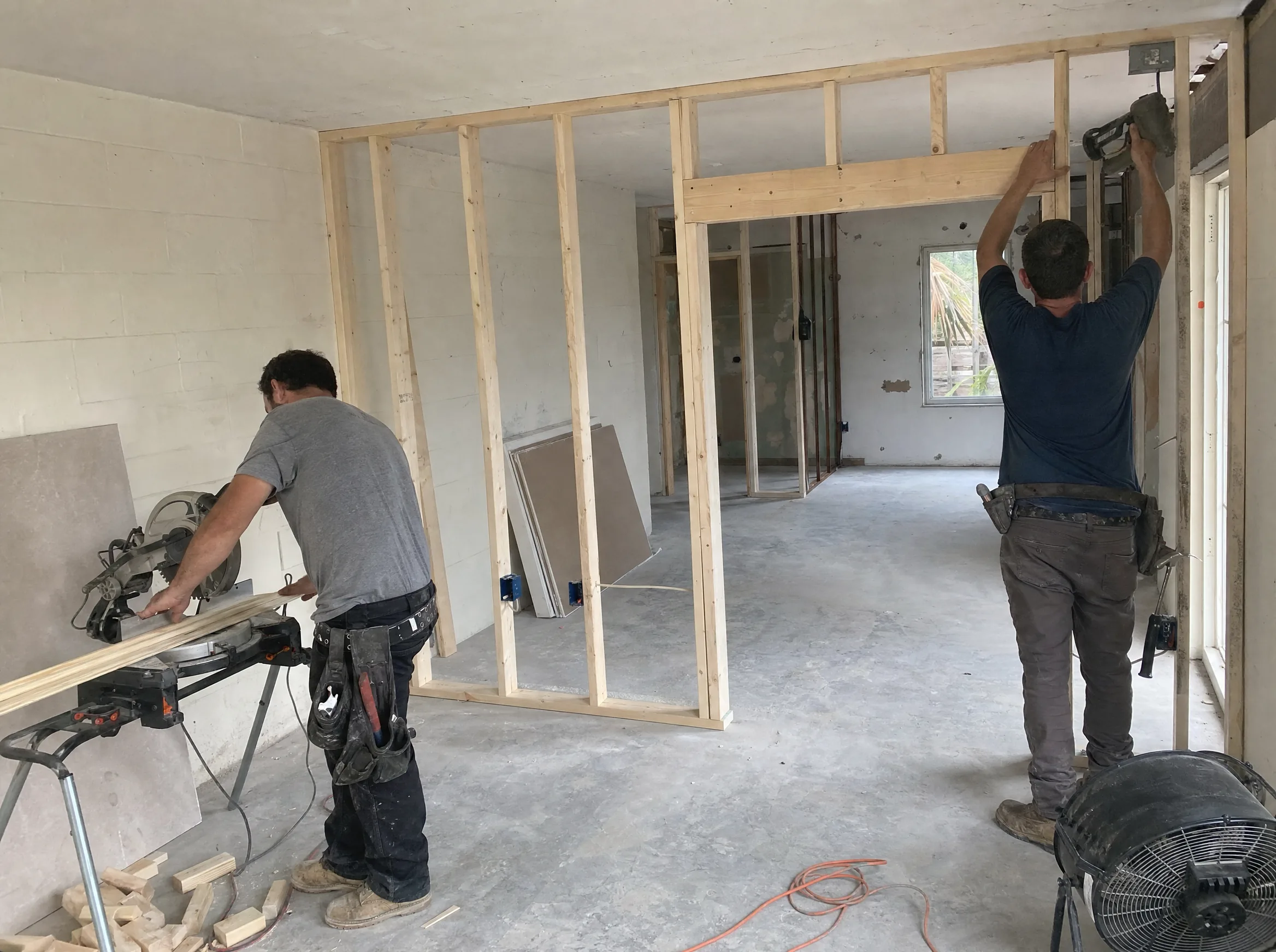 Interior wood framing for a new wall layout during a home renovation managed by a general contractor