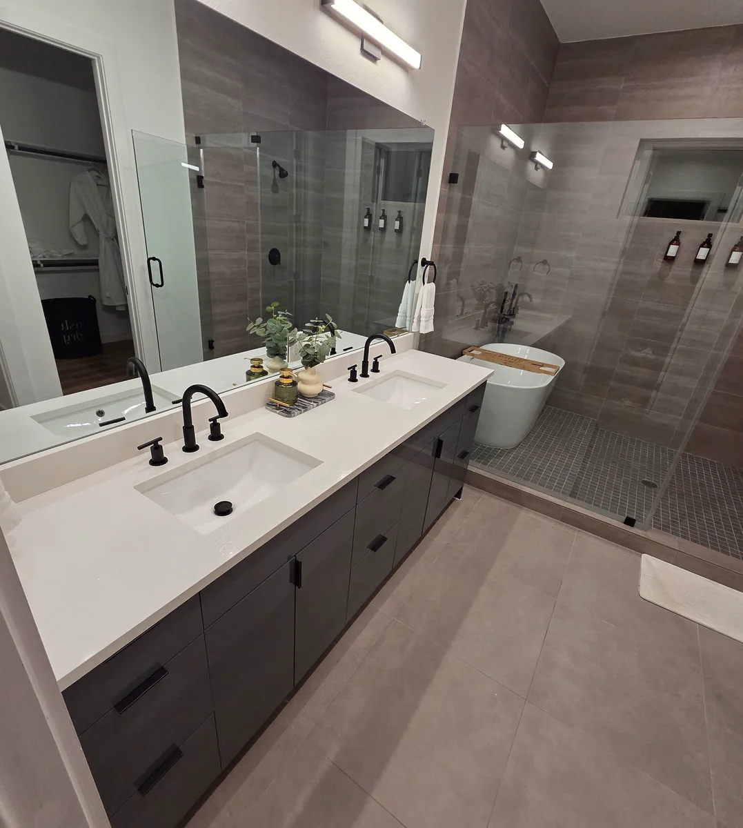 Double vanity and frameless glass shower in a remodeled primary bath