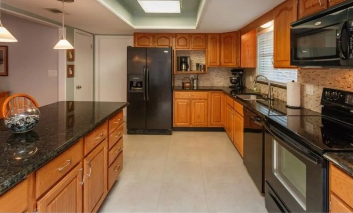 Before: Kitchen before the remodel: dated oak cabinets