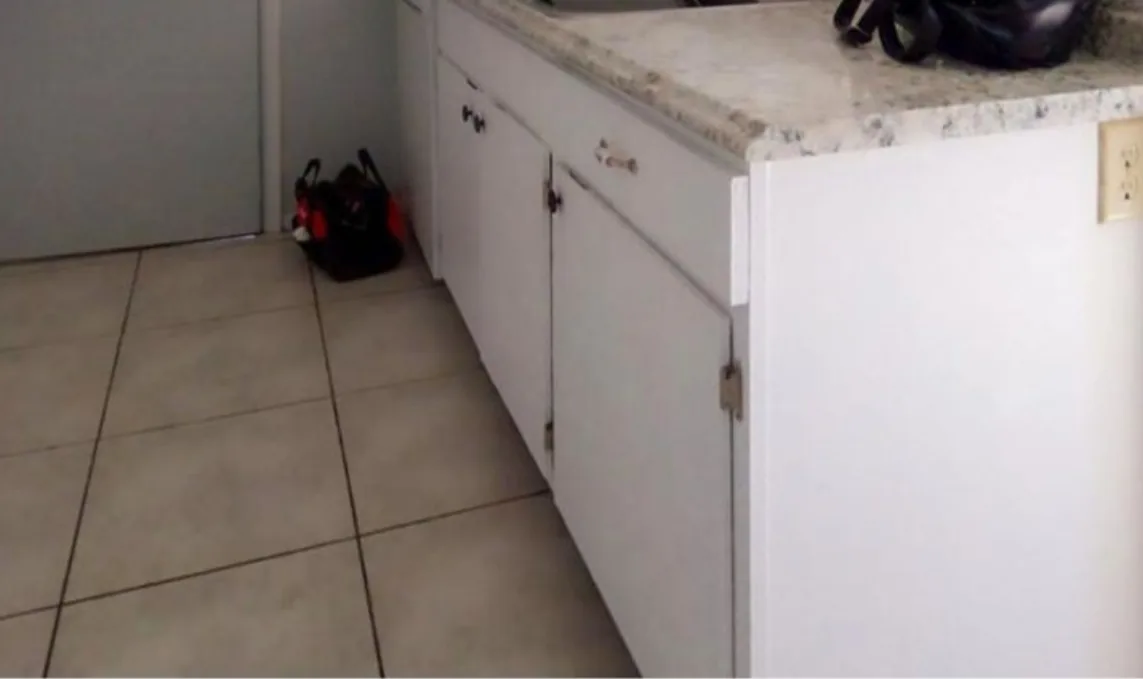 Before: Kitchen before the remodel: worn white peninsula