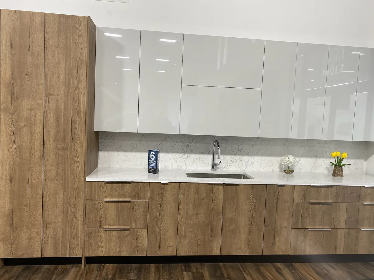 Wood grain base cabinets with white gloss uppers and quartz countertop