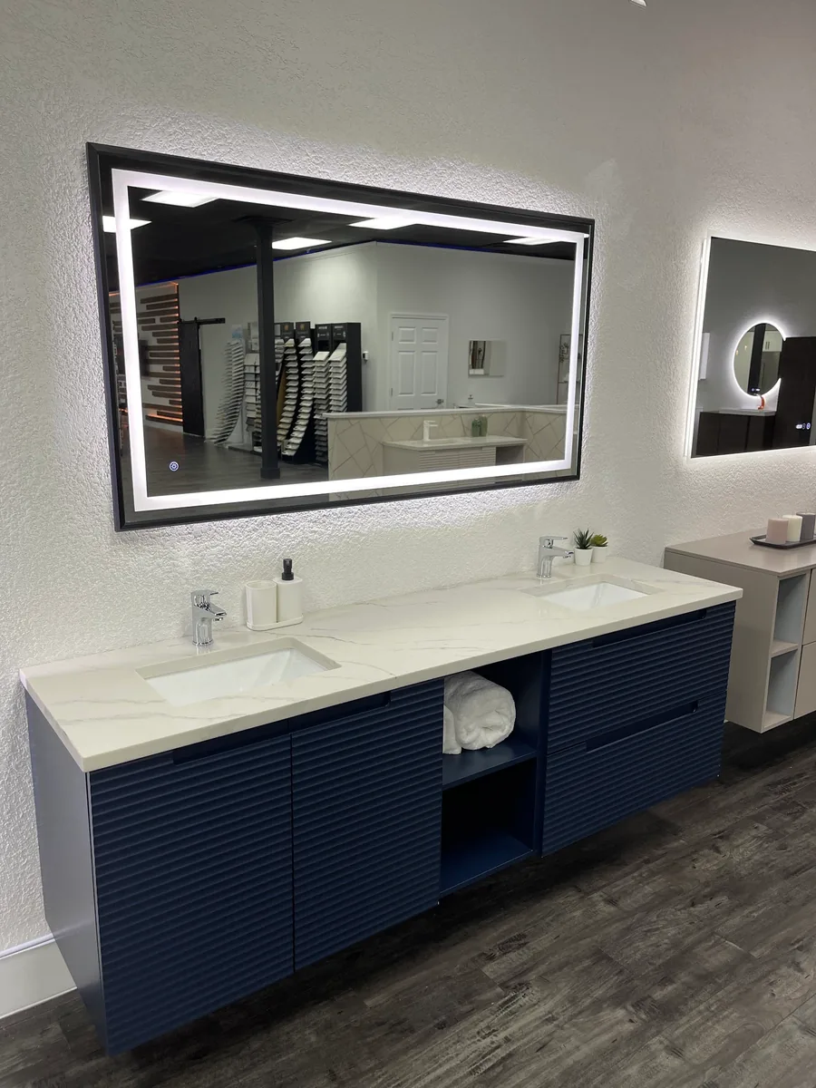Navy double vanity with a large LED mirror in the showroom
